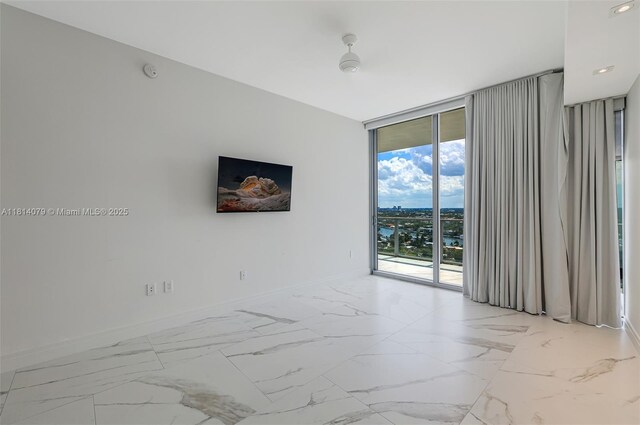 2200 N Ocean Blvd Unit S1801, Fort Lauderdale, FL 33305 - spare room with floor to ceiling windows, baseboards, and light marble finish floors