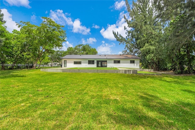 5311 SW 196th Ln, Southwest Ranches, FL 33332 - back of property with a yard, stucco siding, and metal roof