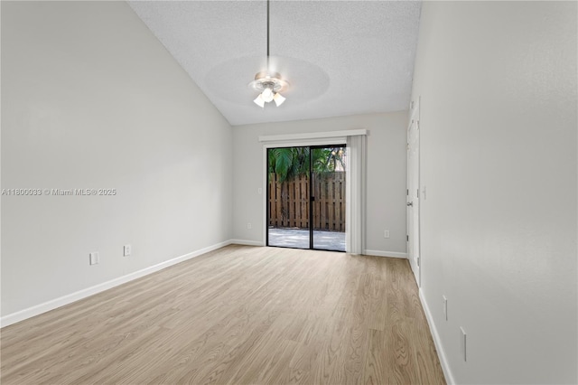 4159 Palm Bay Cir Unit A, West Palm Beach, FL 33406 - empty room with light wood-style flooring, ceiling fan, a textured ceiling, baseboards, and vaulted ceiling