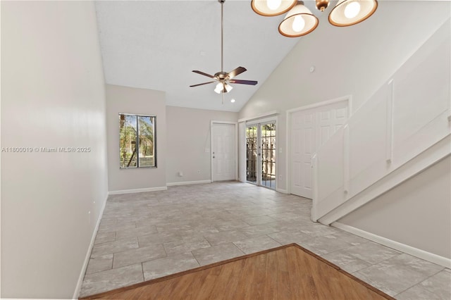 4020 Palm Bay Cir Unit B, West Palm Beach, FL 33406 - unfurnished living room with baseboards, high vaulted ceiling, a ceiling fan, and a chandelier