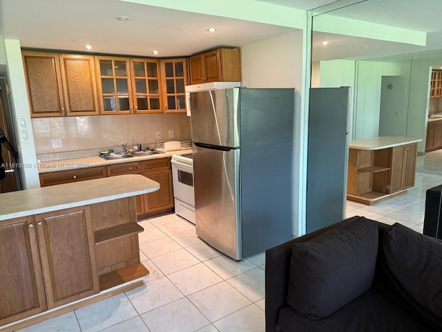 217 Suffolk F Unit 217, Boca Raton, FL 33434 - kitchen with open shelves, freestanding refrigerator, white electric range, a sink, and brown cabinetry