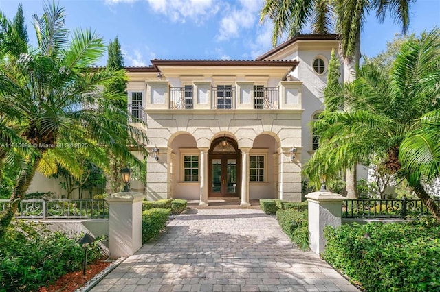 9500 SW 62nd Ct, Pinecrest, FL 33156 - mediterranean / spanish house with french doors, a balcony, stucco siding, and decorative driveway