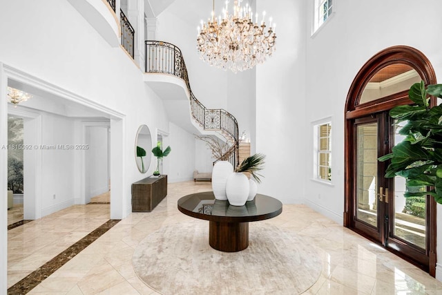 9500 SW 62nd Ct, Pinecrest, FL 33156 - entryway featuring a towering ceiling, stairway, a chandelier, baseboards, and marble tiled floors