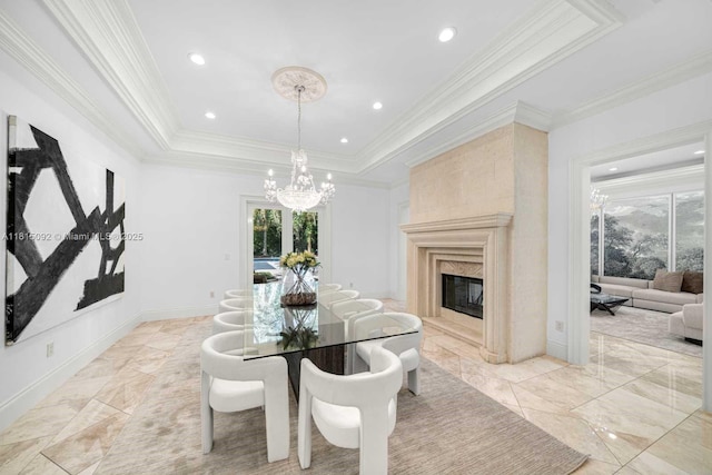 9500 SW 62nd Ct, Pinecrest, FL 33156 - dining space with healthy amount of natural light, a chandelier, a raised ceiling, crown molding, and a premium fireplace