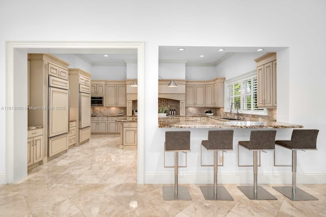 9500 SW 62nd Ct, Pinecrest, FL 33156 - kitchen featuring cream cabinetry, a kitchen breakfast bar, tasteful backsplash, ornamental molding, and recessed lighting