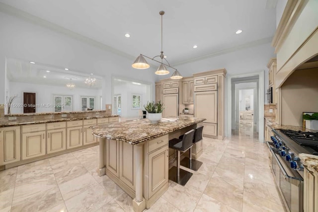9500 SW 62nd Ct, Pinecrest, FL 33156 - kitchen featuring cream cabinetry, decorative light fixtures, a kitchen island, recessed lighting, and light stone counters