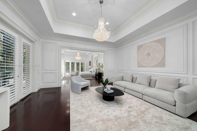 9500 SW 62nd Ct, Pinecrest, FL 33156 - living room featuring a decorative wall, a chandelier, dark wood-type flooring, and crown molding