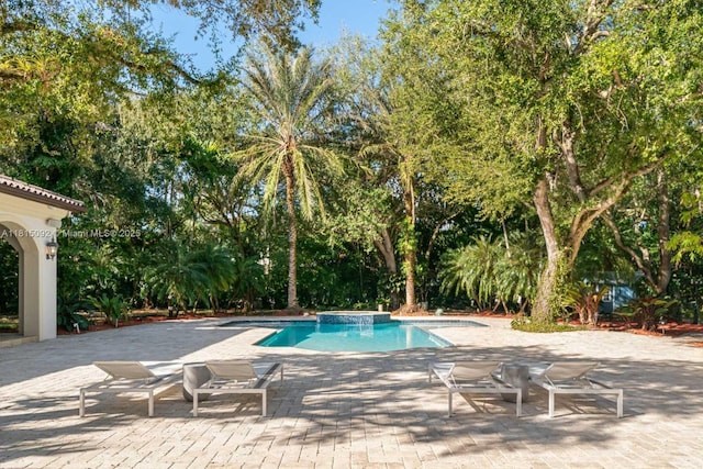 9500 SW 62nd Ct, Pinecrest, FL 33156 - swimming pool featuring a patio area and view of wooded area