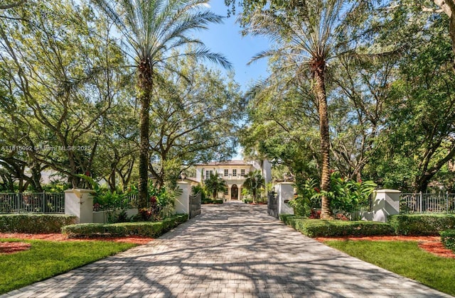 9500 SW 62nd Ct, Pinecrest, FL 33156 - view of community featuring a fenced front yard, decorative driveway, and a gate