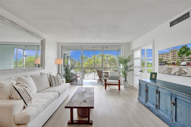 3150 N Course Ln Unit 405, Pompano Beach, FL 33069 - living room with healthy amount of natural light and light wood-style flooring