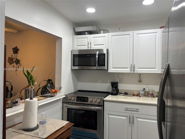 9041 Sunrise Lakes Blvd Unit 311, Sunrise, FL 33322 - kitchen featuring appliances with stainless steel finishes, white cabinetry, recessed lighting, and light countertops