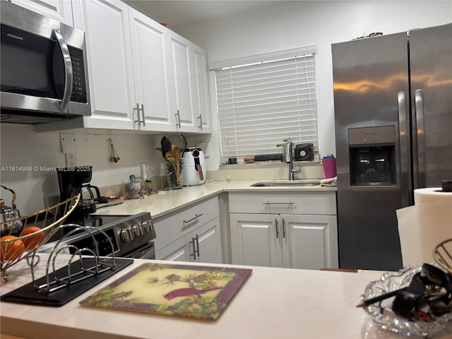 9041 Sunrise Lakes Blvd Unit 311, Sunrise, FL 33322 - kitchen featuring appliances with stainless steel finishes, white cabinetry, light countertops, and a sink