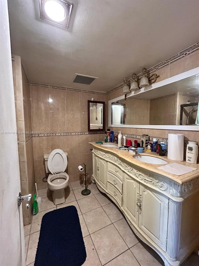 920 Ne 199th St 2S Apt 217, Miami, FL 33179 - bathroom with tile walls, tile patterned flooring, and double vanity