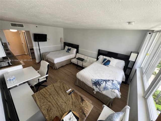 19201 Collins Ave Unit 427, Sunny Isles Beach, FL 33160 - bedroom featuring a textured ceiling and wood finished floors