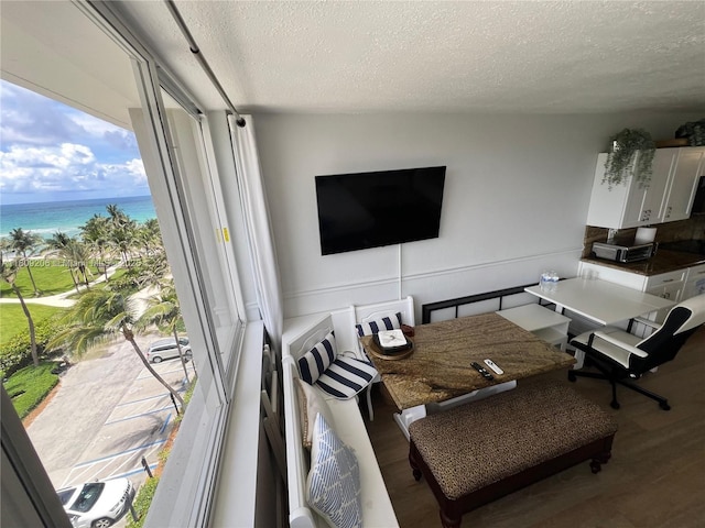 19201 Collins Ave Unit 427, Sunny Isles Beach, FL 33160 - living room featuring a textured ceiling, wood finished floors, and a water view
