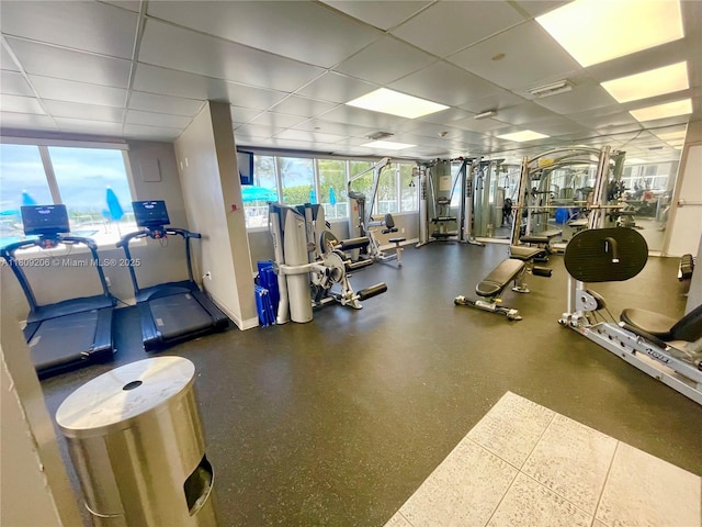 19201 Collins Ave Unit 427, Sunny Isles Beach, FL 33160 - gym featuring baseboards and a paneled ceiling