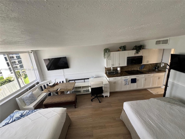 19201 Collins Ave Unit 427, Sunny Isles Beach, FL 33160 - living room featuring a textured ceiling and wood finished floors