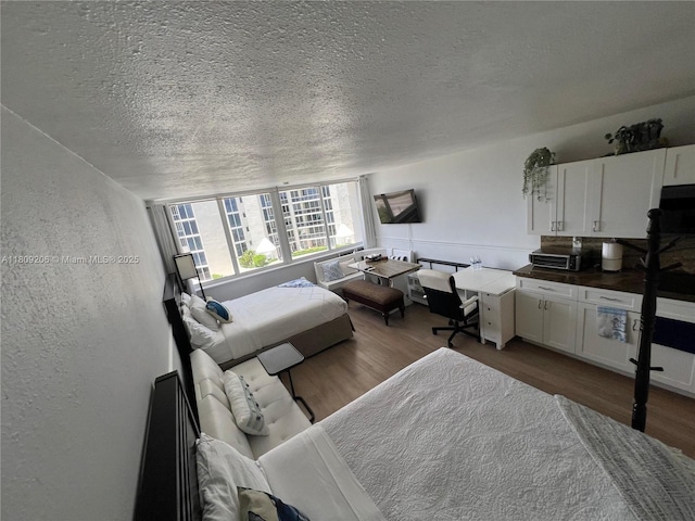 19201 Collins Ave Unit 427, Sunny Isles Beach, FL 33160 - bedroom featuring dark wood-type flooring, a textured ceiling, and a textured wall