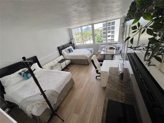 19201 Collins Ave Unit 427, Sunny Isles Beach, FL 33160 - bedroom with a textured ceiling and wood finished floors