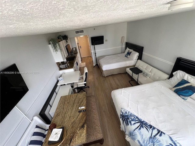 19201 Collins Ave Unit 427, Sunny Isles Beach, FL 33160 - bedroom with a textured ceiling and wood finished floors