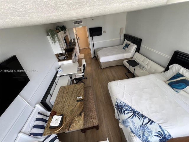 19201 Collins Ave Unit 427, Sunny Isles Beach, FL 33160 - bedroom featuring wood finished floors and a textured ceiling