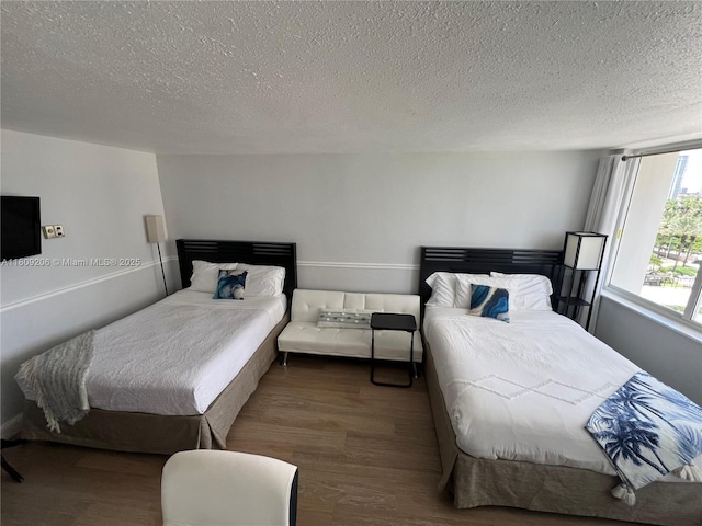 19201 Collins Ave Unit 427, Sunny Isles Beach, FL 33160 - bedroom featuring wood finished floors and a textured ceiling