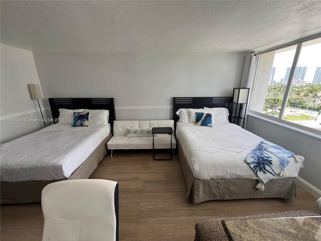 19201 Collins Ave Unit 427, Sunny Isles Beach, FL 33160 - bedroom featuring wood finished floors and a textured ceiling
