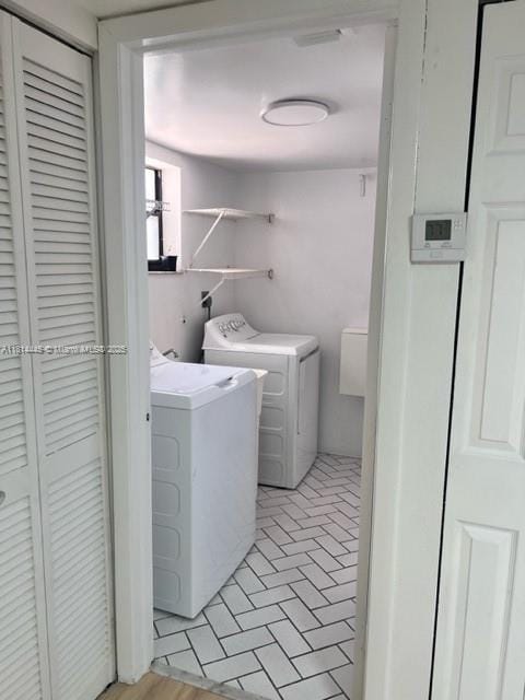 958 Mockingbird Ln Unit 511, Plantation, FL 33324 - laundry room with washer and clothes dryer and brick patterned floors