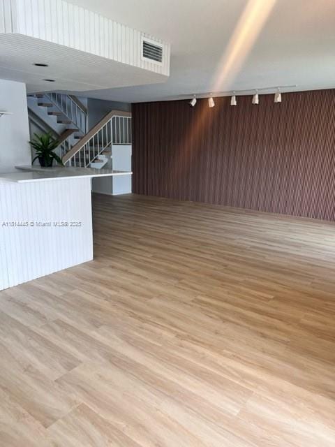 958 Mockingbird Ln Unit 511, Plantation, FL 33324 - empty room featuring track lighting, stairway, and light wood-style flooring