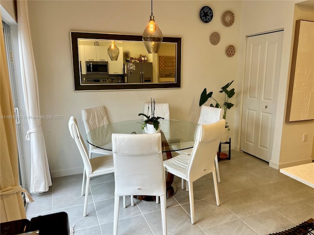 12254 NW 24th Pl, Miami, FL 33167 - dining area with baseboards and light tile patterned flooring