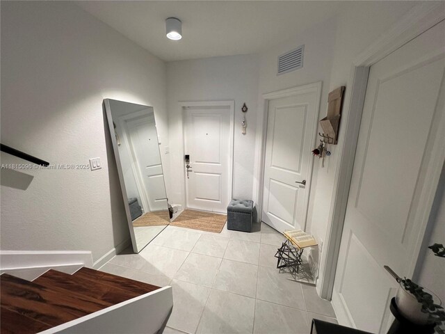 12254 NW 24th Pl, Miami, FL 33167 - hallway with light tile patterned flooring and baseboards