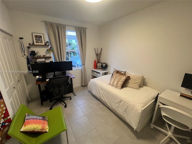 12254 NW 24th Pl, Miami, FL 33167 - bedroom featuring an office area, light tile patterned flooring, and baseboards
