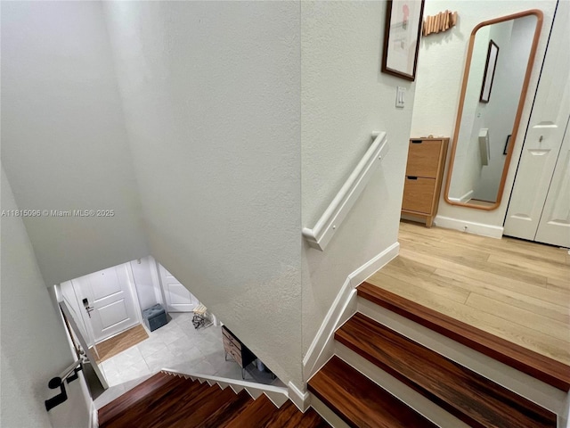 12254 NW 24th Pl, Miami, FL 33167 - stairway featuring wood finished floors, baseboards, and a textured wall