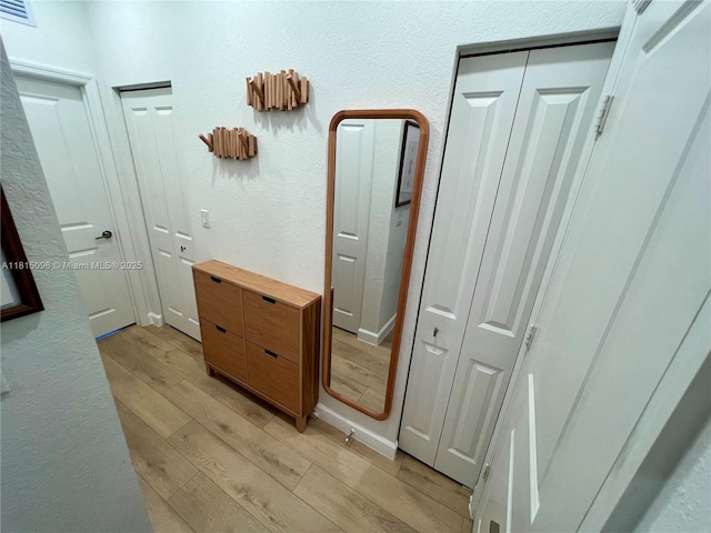 12254 NW 24th Pl, Miami, FL 33167 - hall with light wood-style flooring and a textured wall