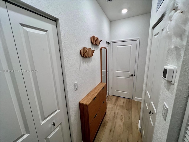 12254 NW 24th Pl, Miami, FL 33167 - hallway with a textured wall and light wood-style floors