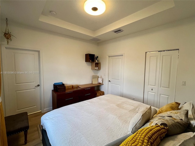 12254 NW 24th Pl, Miami, FL 33167 - bedroom featuring wood finished floors and a tray ceiling