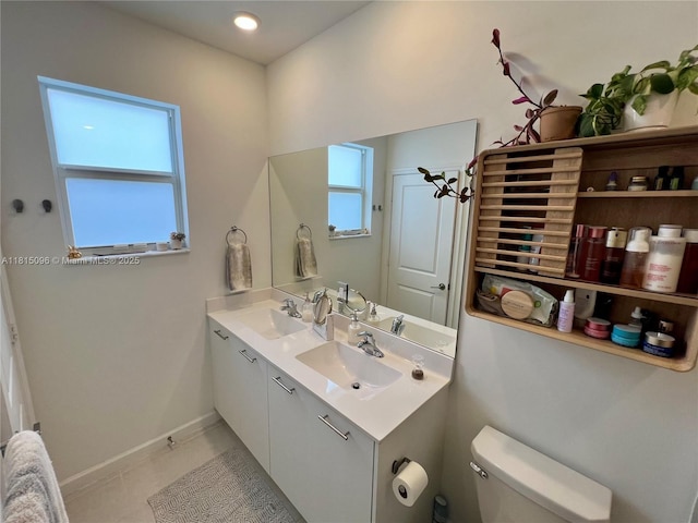 12254 NW 24th Pl, Miami, FL 33167 - bathroom with double vanity, toilet, baseboards, and tile patterned flooring