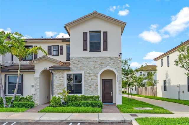 12945 SW 234th St, Homestead, FL 33032 - view of property with stucco siding, stone siding, and a tile roof