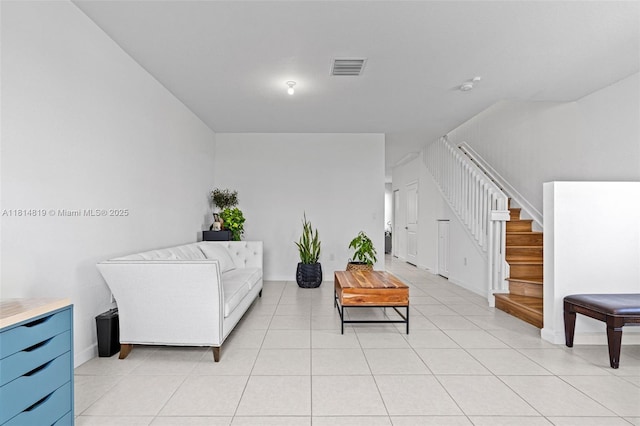 12945 SW 234th St, Homestead, FL 33032 - sitting room with stairway, light tile patterned floors, and baseboards