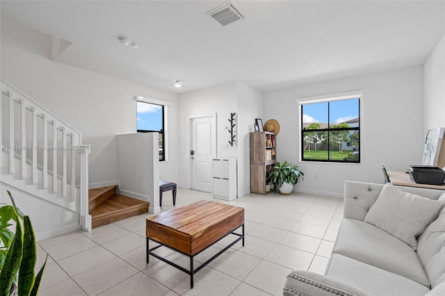 12945 SW 234th St, Homestead, FL 33032 - living area featuring stairs, plenty of natural light, light tile patterned floors, and baseboards