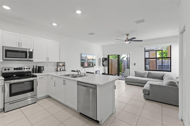12945 SW 234th St, Homestead, FL 33032 - kitchen featuring stainless steel appliances, a sink, a peninsula, light countertops, and recessed lighting