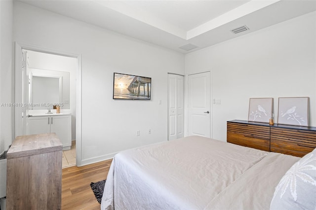 12945 SW 234th St, Homestead, FL 33032 - bedroom with light wood-style flooring, ensuite bath, and baseboards