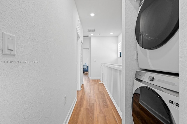 12945 SW 234th St, Homestead, FL 33032 - laundry room featuring stacked washer / dryer, light wood-type flooring, a textured wall, recessed lighting, and baseboards