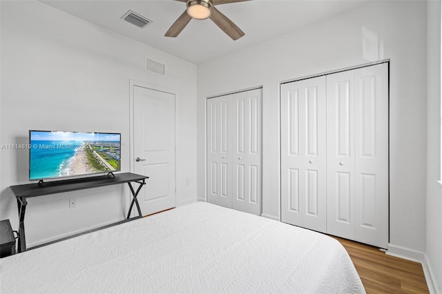 12945 SW 234th St, Homestead, FL 33032 - bedroom featuring two closets, wood finished floors, baseboards, and a ceiling fan