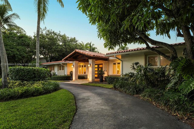 7505 SW 129th St, Pinecrest, FL 33156 - view of front of property with stucco siding, a tiled roof, asphalt driveway, and french doors