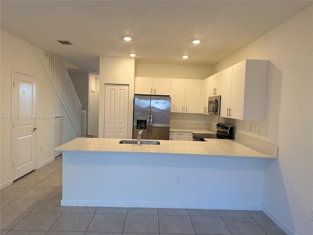 23235 SW 129th Path, Miami, FL 33170 - kitchen with stainless steel appliances, a sink, light countertops, light tile patterned flooring, and recessed lighting