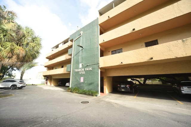 1750 W 56th St Unit 108, Hialeah, FL 33012 - view of building exterior featuring covered parking