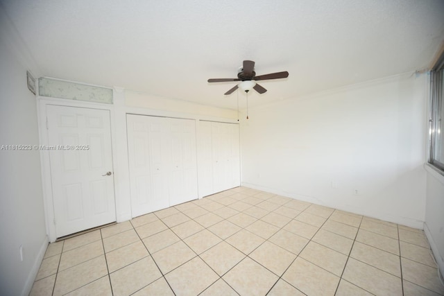 1750 W 56th St Unit 108, Hialeah, FL 33012 - unfurnished bedroom featuring baseboards, ceiling fan, and light tile patterned floors