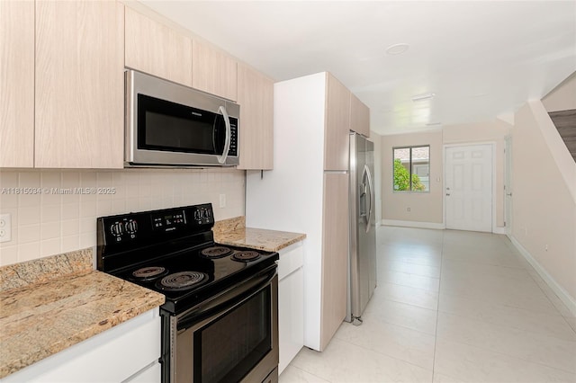 815 NW 3rd Ave, Fort Lauderdale, FL 33311 - kitchen with stainless steel appliances, decorative backsplash, light brown cabinets, light stone countertops, and modern cabinets