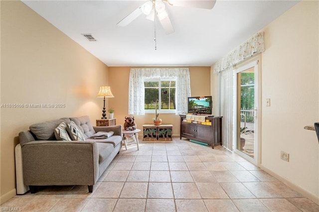 4559 Springview Cir, La Belle, FL 33935 - living room with ceiling fan, light tile patterned floors, and baseboards